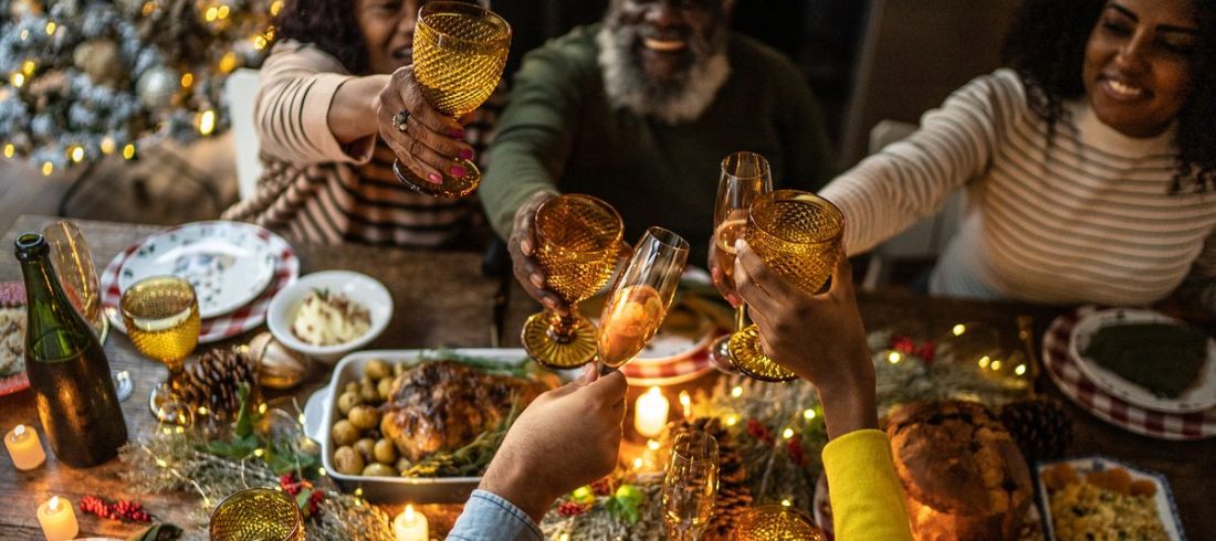 Family toasting over a holiday meal