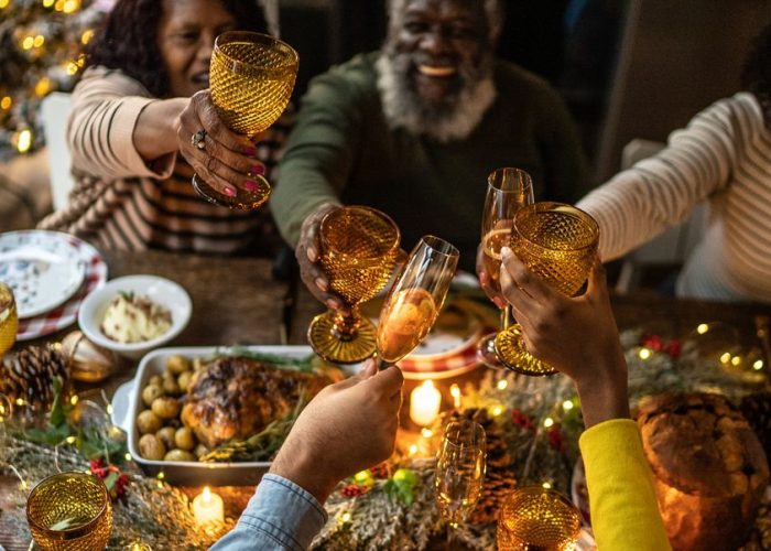 Family toasting over a holiday meal